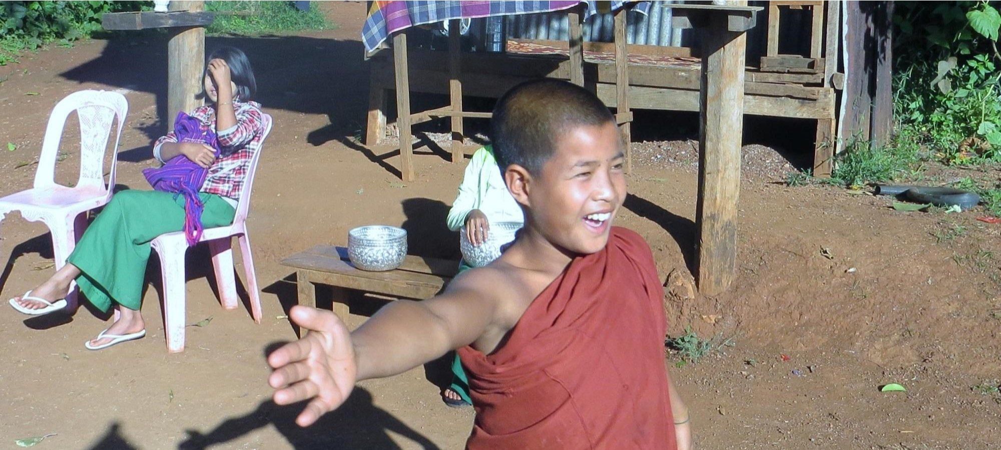 Young Monk giving cyclists the high 5 
